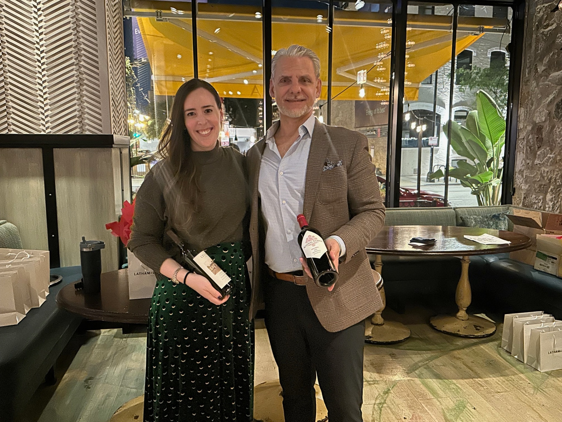 Sommelier Michael Bottigliero with a client holding hand-picked bottles at a tasting event